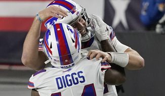 Buffalo Bills quarterback Josh Allen, rear, celebrates his touchdown pass to Stefon Diggs, front, in the first half of an NFL football game against the New England Patriots, Monday, Dec. 28, 2020, in Foxborough, Mass. (AP Photo/Charles Krupa)