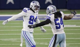 Dallas Cowboys defensive end Randy Gregory (94) and Jaylon Smith (54) celebrate after Gregory sacked Philadelphia Eagles&#39; Jalen Hurts in the second half of an NFL football game in Arlington, Texas, Sunday, Dec. 27. 2020. (AP Photo/Michael Ainsworth)