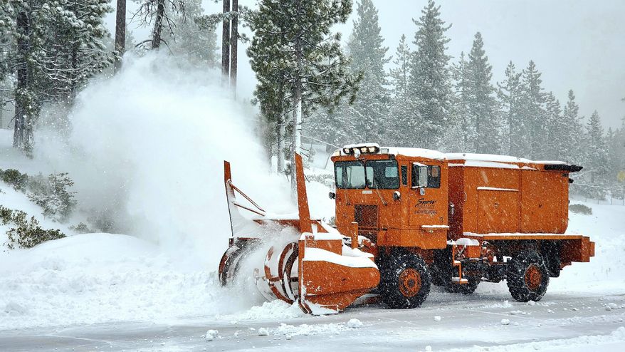 In this photo provided by Snow Valley Mountain Resort a snowplow clearing a road near the ski area at Running Springs in the San Gabriel Mountains of Southern California Monday, Dec. 28, 2020. Rain, hail, and snow fell Monday as Southern California saw its first significant storm of the season. Lightning flashed and thunder sounded as the storm front swept across the region in the middle of the night, unleashing downpours followed by bands of rain that were expected to continue through the afternoon. (Snow Valley Mountain Resort via AP)