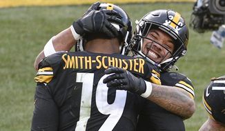 Pittsburgh Steelers wide receiver JuJu Smith-Schuster (19) celebrates with running back James Conner (30) after making a touchdown catch against the Indianapolis Colts during the second half of an NFL football game, Sunday, Dec. 27, 2020, in Pittsburgh. (AP Photo/Don Wright)