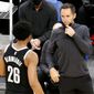 Brooklyn Nets head coach Steve Nash, right, talks with Spencer Dinwiddie during the first half of an NBA preseason basketball game against the Boston Celtics, Friday, Dec. 18, 2020, in Boston. (AP Photo/Mary Schwalm)