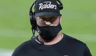 Las Vegas Raiders head coach Jon Gruden stands on the sidelines during the first half of an NFL football game against the Miami Dolphins, Saturday, Dec. 26, 2020, in Las Vegas. (AP Photo/Steve Marcus)