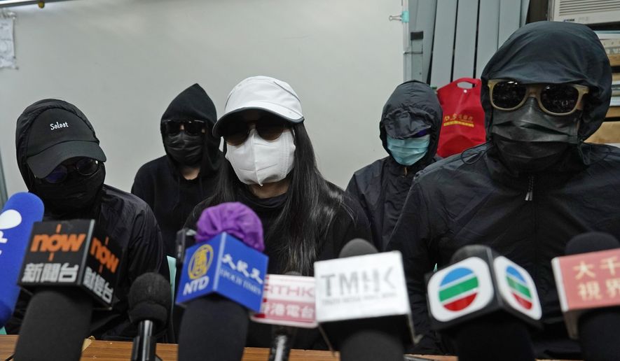 Relatives of 12 Hong Kong activists detained at sea by Chinese authorities, attend a press conference in Hong Kong, Monday, Dec. 28, 2020. Trials for 10 people accused of attempting to flee Hong Kong by speedboat amid a government crackdown on dissent got underway in China on Monday, a court official said. The defendants face charges of illegally crossing the border, while two face additional charges of organizing the attempt, according to an indictment issued in the southern city of Shenzhen. (AP Photo/Kin Cheung)