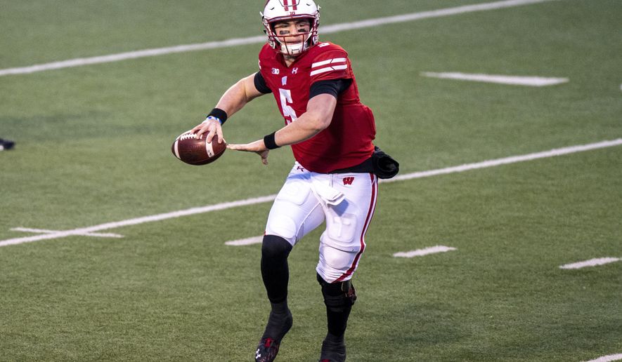 Wisconsin quarterback Graham Mertz (5) passes against Minnesota during the first half of an NCAA college football game Saturday, Dec. 19, 2020, in Madison, Wis. (AP Photo/Andy Manis)
