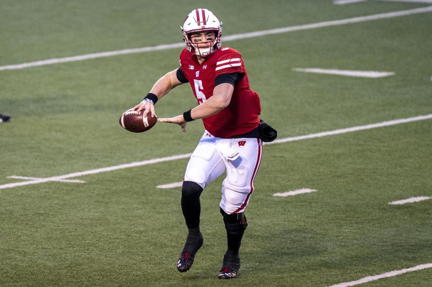 Wisconsin quarterback Graham Mertz (5) passes against Minnesota during the first half of an NCAA college football game Saturday, Dec. 19, 2020, in Madison, Wis. (AP Photo/Andy Manis)