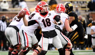 Georgia quarterback JT Daniels throws during the first half of an NCAA college football game against Missouri Saturday, Dec. 12, 2020, in Columbia, Mo. Cincinnati&#39;s Desmond Ridder is known for his dual-threat skills. JT Daniels has used his arm strength to add balance to Georgia&#39;s attack. The two quarterbacks also boast impressive football intelligence, and that may be the biggest reason neither has lost a game as a starter this season as they prepare to meet in Friday&#39;s Peach Bowl.(AP Photo/L.G. Patterson)
