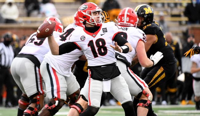 Georgia quarterback JT Daniels throws during the first half of an NCAA college football game against Missouri Saturday, Dec. 12, 2020, in Columbia, Mo. Cincinnati&#x27;s Desmond Ridder is known for his dual-threat skills. JT Daniels has used his arm strength to add balance to Georgia&#x27;s attack. The two quarterbacks also boast impressive football intelligence, and that may be the biggest reason neither has lost a game as a starter this season as they prepare to meet in Friday&#x27;s Peach Bowl.(AP Photo/L.G. Patterson)