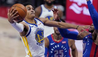 Golden State Warriors guard Jordan Poole (3) makes a layup as Detroit Pistons guard Saddiq Bey (41) defends during the first half of an NBA basketball game Tuesday, Dec. 29, 2020, in Detroit. (AP Photo/Carlos Osorio)