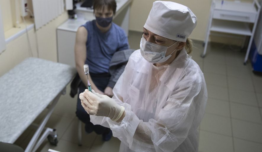 A medical worker, right, prepares a shot of Russia&#39;s Sputnik V coronavirus vaccine in Moscow, Russia, Wednesday, Dec. 30, 2020. Russia&#39;s Health Ministry has allowed a domestically designed coronavirus vaccine to be given to people older than 60. Sputnik V&#39;s developers have said data suggests the vaccine was 91% effective, a conclusion based on 78 coronavirus infections among nearly 23,000 participants. That&#39;s far fewer cases than Western drugmakers have accumulated during final testing before analyzing how well their vaccine candidates worked. (AP Photo/Pavel Golovkin)