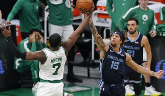 Boston Celtics&#39; Jaylen Brown (7) and Memphis Grizzlies&#39; Brandon Clarke (15) battle for a rebound during the first half of an NBA basketball game, Wednesday, Dec. 30, 2020, in Boston. (AP Photo/Michael Dwyer)