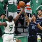 Boston Celtics&#39; Jaylen Brown (7) and Memphis Grizzlies&#39; Brandon Clarke (15) battle for a rebound during the first half of an NBA basketball game, Wednesday, Dec. 30, 2020, in Boston. (AP Photo/Michael Dwyer)