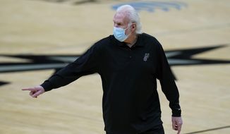San Antonio Spurs coach Gregg Popovich walks off the court after he was ejected during the first half of the team&#39;s NBA basketball game against the Los Angeles Lakers in San Antonio, Wednesday, Dec. 30, 2020. (AP Photo/Eric Gay)