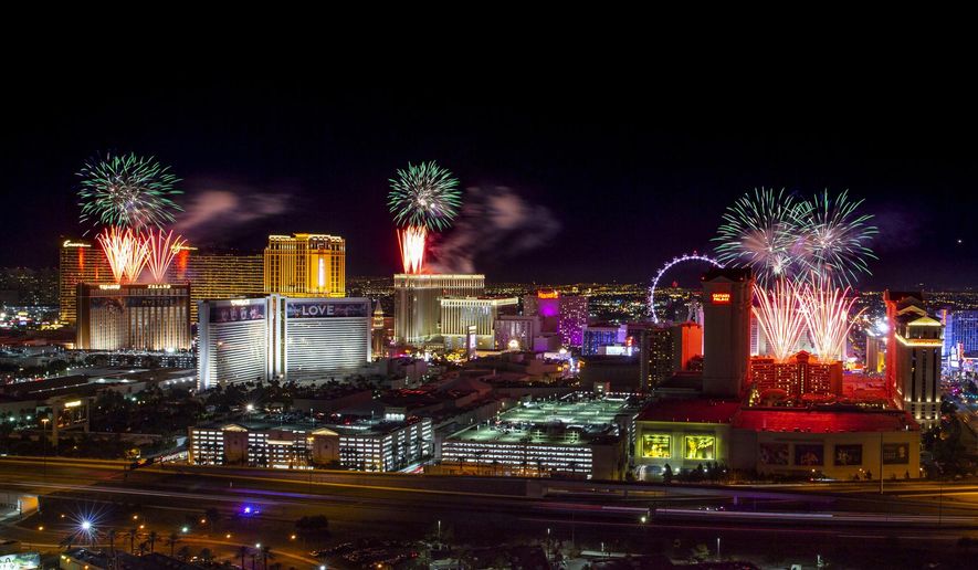 FILE- IN this Jan. 1, 2020 file photo, fireworks for New Year's Eve erupt over the Strip as viewed from the VooDoo Rooftop Nightclub & Lounge at Rio All-Suite Hotel & Casino on in Las Vegas. If ever a year's end seemed like cause for celebration, 2020 might be it. Yet the coronavirus scourge that dominated the year is also looming over New Year's festivities and forcing officials worldwide to tone them down. (L.E. Baskow/Las Vegas Review-Journal via AP, File)