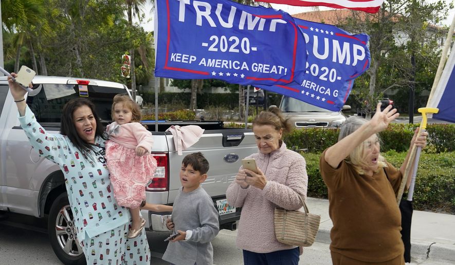 Supporters of President Donald Trump stand on the side of a road as Trump&#39;s motorcade passes by, Wednesday, Dec. 30, 2020, in West Palm Beach, Fla. Trump is returning to his Mar-a-Lago resort in Palm Beach, Fla., after visiting Trump International Golf Club. (AP Photo/Patrick Semansky)