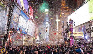 FILE - In this Jan. 1, 2020, file photo, confetti falls at midnight on the Times Square New Year&#39;s Eve celebration in New York. If ever a year&#39;s end seemed like cause for celebration, 2020 might be it. Yet the coronavirus scourge that dominated the year is also looming over New Year&#39;s festivities and forcing officials worldwide to tone them down. (Photo by Ben Hider/Invision/AP, File)