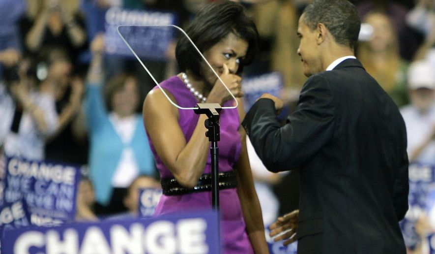 FILE - This June 3, 2008, file photo shows then Democratic presidential candidate Sen. Barack Obama fist bump with his wife Michelle, before speaking at a primary night rally in St. Paul, Minn. Barack and Michelle Obama famously fist-bumped when he clinched the Democratic presidential nomination in June 2008, making the move very cool in some circles, causing outrage in others. (AP Photo/Morry Gash, File)