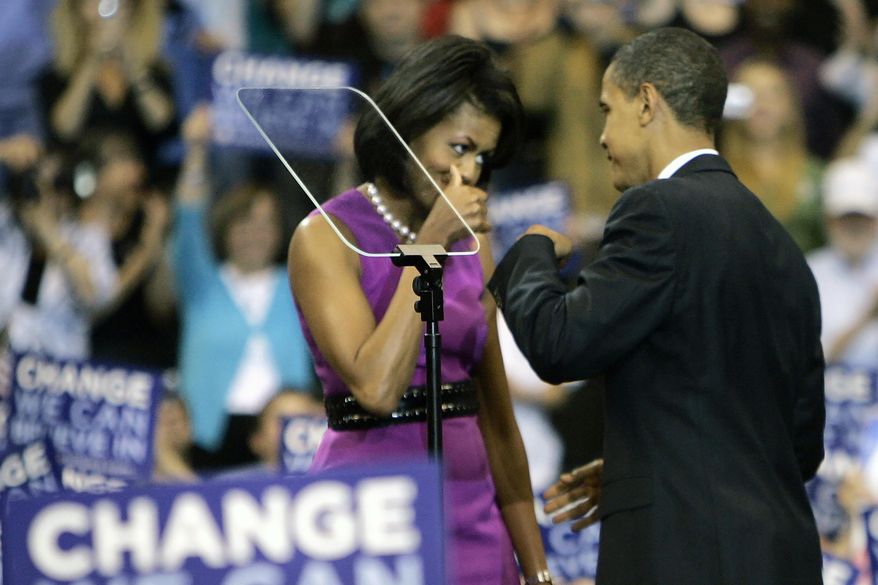 FILE - This June 3, 2008, file photo shows then Democratic presidential candidate Sen. Barack Obama fist bump with his wife Michelle, before speaking at a primary night rally in St. Paul, Minn. Barack and Michelle Obama famously fist-bumped when he clinched the Democratic presidential nomination in June 2008, making the move very cool in some circles, causing outrage in others. (AP Photo/Morry Gash, File)