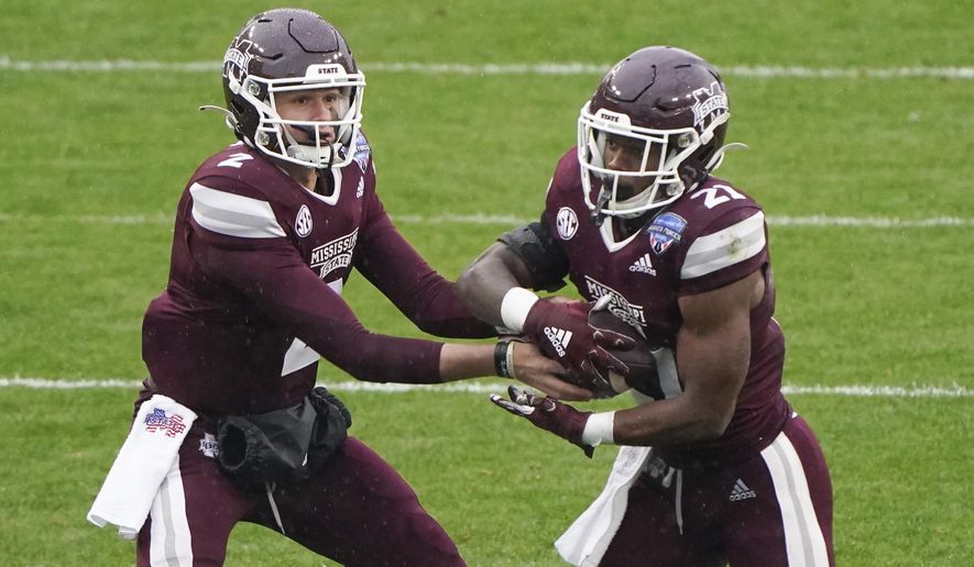Mississippi State quarterback Will Rogers (2) hands the ball to running back Jo&#39;Quavious Marks (21) against Tulsa during the first half of the Armed Forces Bowl NCAA college football game Thursday, Dec. 31, 2020, in Fort Worth, Texas. (AP Photo/Jim Cowsert)