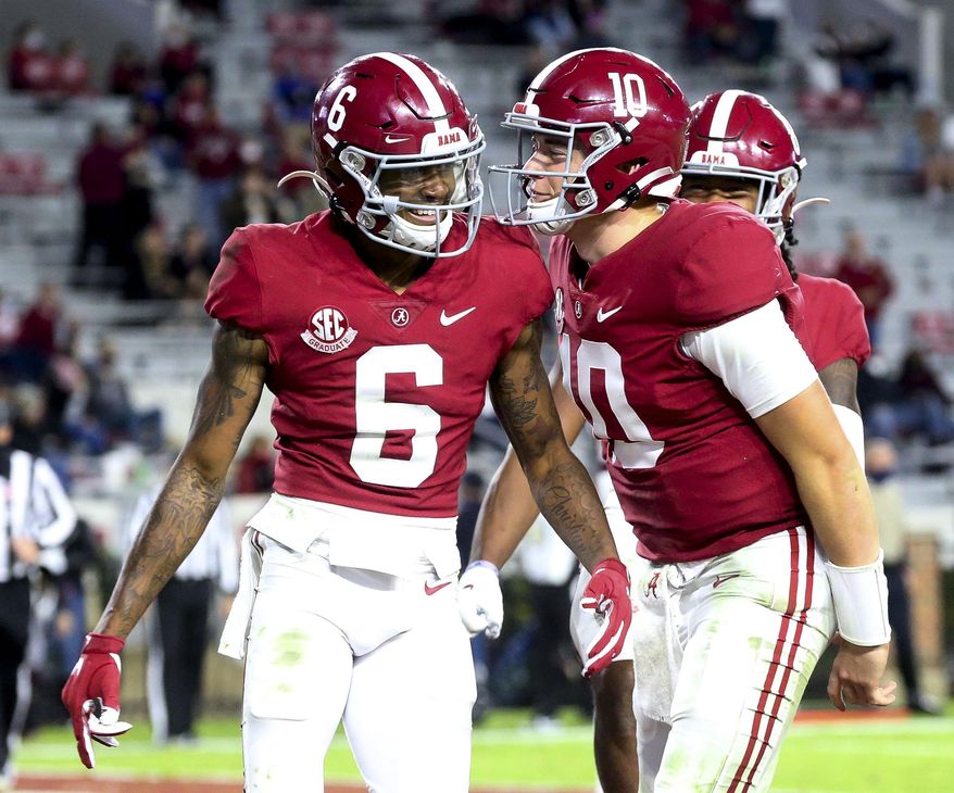 FILE - Alabama wide receiver DeVonta Smith (6) and quarterback Mac Jones (10) celebrate a touchdown pass during the second half of an NCAA college football game against Mississippi State in Tuscaloosa, Ala., in this Saturday, Oct. 31, 2020. Notre Dame is the underdog against Alabama with Heisman Trophy finalists quarterback Mac Jones and receiver DeVonta Smith, in the Rose Bowl on New Year's Day at AT&T Stadium. (Gary Cosby Jr./The Tuscaloosa News via AP, File)