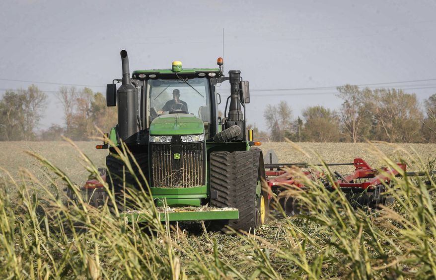 FILE - In this Aug. 26, 2020 file photo, a farmer discs over a corn field on at a farm north of Woodward, Iowa. The corn was damaged beyond salvage by the recent derecho. Thanks to the government paying nearly 40% of their income, U.S. farmers are expected to end 2020 with higher profit than 2019 and the best net income in seven years, the Department of Agriculture said in its latest farm income forecast. Farmers faced challenges throughout 2020 that included the impact of trade disputes; low prices that drove down cash receipts and weather difficulties. (Bryon Houlgrave/The Des Moines Register via AP File)