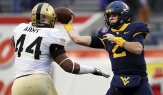 West Virginia quarterback Jarrett Doege (2) throws a pass while under pressure from Army linebacker Nathaniel Smith (44) during the first half of the Liberty Bowl NCAA college football game in Memphis, Tenn., Thursday, Dec. 31, 2020. (Patrick Lantrip/Daily Memphian via AP)