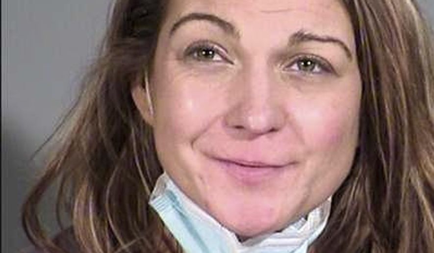 This December 2020 booking photo provided by the Maricopa County Sheriff's Office shows Sarah Michelle Boone in Phoenix. Boone, 32, is accused of assaulting her children and stepchildren for not wearing masks after they tested positive for COVID-19. She is facing charges of child abuse, assault, disorderly conduct and resisting arrest. (Maricopa County Sheriff's Office via AP)