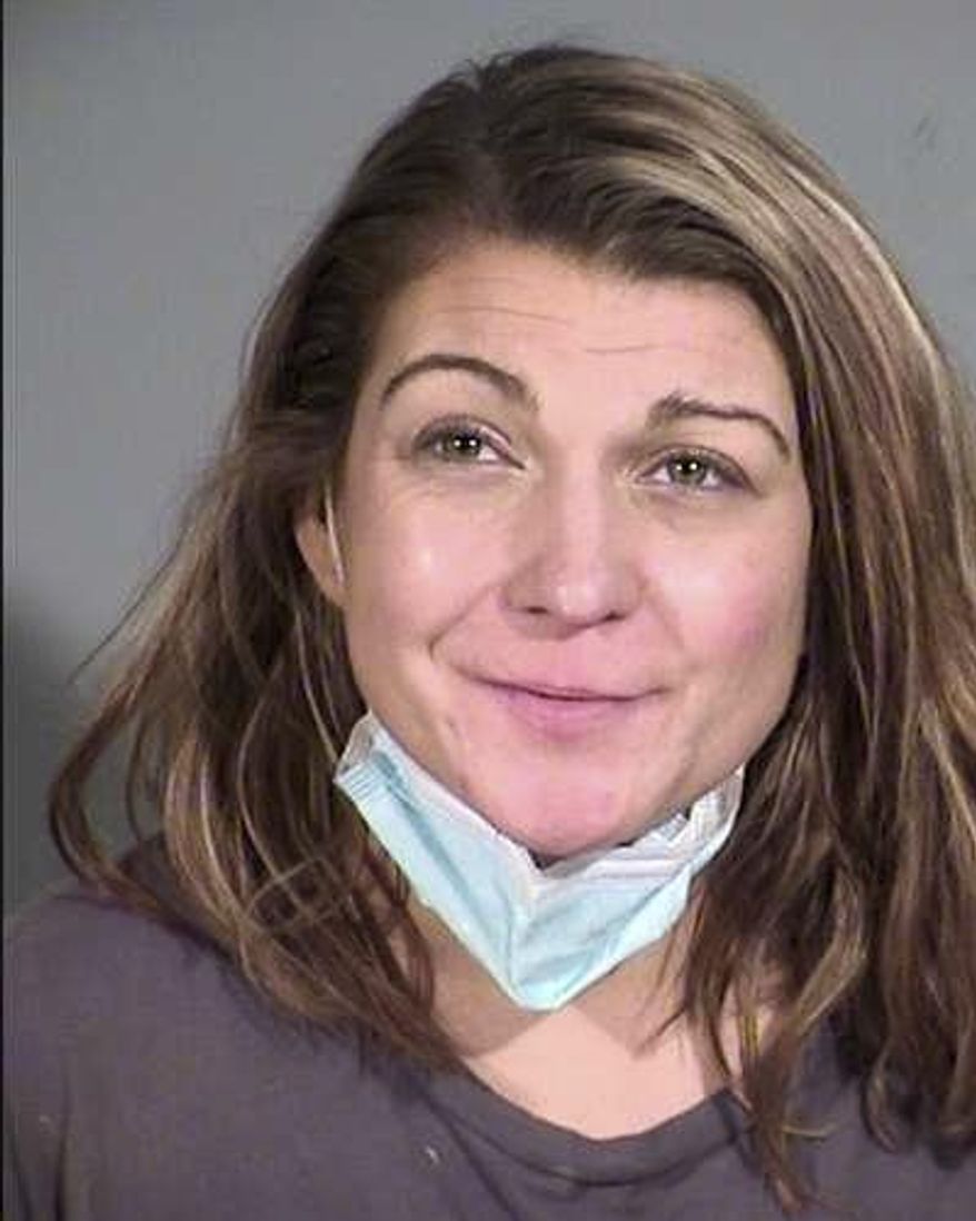 This December 2020 booking photo provided by the Maricopa County Sheriff's Office shows Sarah Michelle Boone in Phoenix. Boone, 32, is accused of assaulting her children and stepchildren for not wearing masks after they tested positive for COVID-19. She is facing charges of child abuse, assault, disorderly conduct and resisting arrest. (Maricopa County Sheriff's Office via AP)
