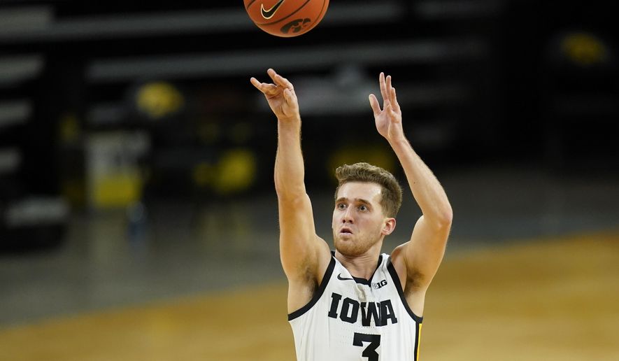 Iowa guard Jordan Bohannon shoots a 3-point basket during the second half of an NCAA college basketball game against Northwestern, Tuesday, Dec. 29, 2020, in Iowa City, Iowa. Iowa won 87-72. (AP Photo/Charlie Neibergall)