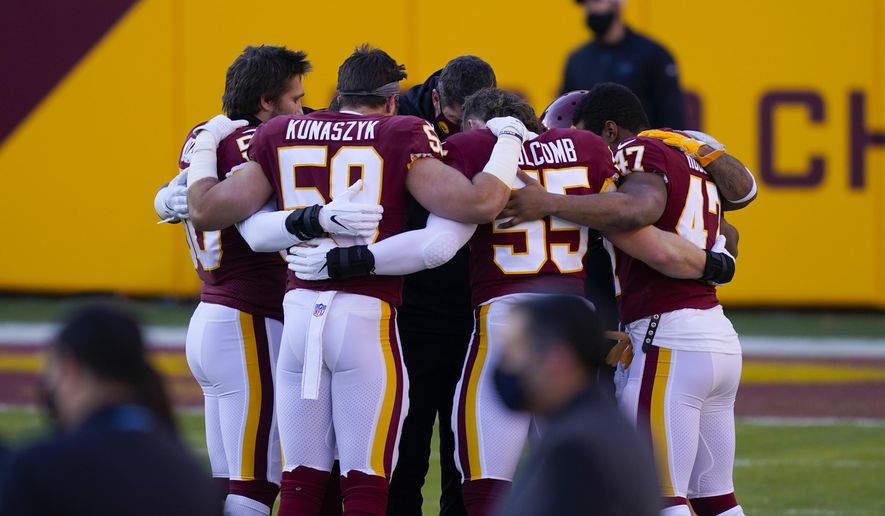 Members of the Washington Football Team huddle together before the start of an NFL football game against the Carolina Panthers, Sunday, Dec. 27, 2020, in Landover, Md. (AP Photo/Mark Tenally)