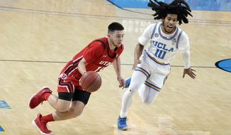 Utah guard Rylan Jones, left, dribbles past UCLA guard Tyger Campbell (10) during the first half of an NCAA college basketball game Thursday, Dec. 31, 2020, in Los Angeles. (AP Photo/Marcio Jose Sanchez)