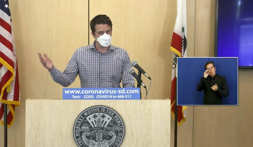 In this photo taken from streaming video from the County of San Diego, is Dr. Kristian Andersen among others, announcing that California's first detected case of the new and apparently more contagious variant of the coronavirus was found in a San Diego man, Wednesday, Dec. 30, 2020. San Diego County officials said the infected man is a 30-year-old with no history of travel. Andersen said the emergence of the new variant underscores the need for social distancing and mask wearing. (County of San Diego via AP)