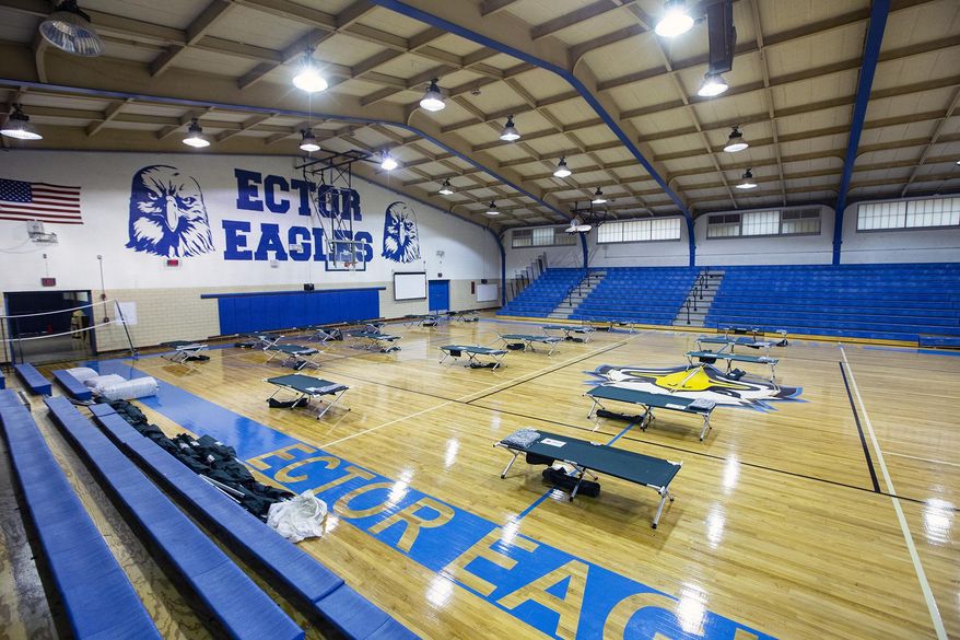 The City of Odessa is opening a temporary weather shelter at Ector College Prep Success Academy Gymnasium at 809 West Clements for those in need of a place during the winter storm Wednesday, Dec. 30, 2020, in Odessa, Texas. The shelter will be open from 5 p.m. Wednesday and remain open until noon on Friday. Food, bedding, showers and restrooms facilities will be available for those who are seeking shelter as well as 24-hour security onsite. The shelter will be following the CDC's guidelines for COVID-19 to ensure a safe environment. (Jacob Ford/Odessa American via AP)
