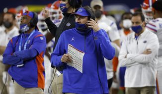 Florida coach Dan Mullen, center, watches play against Oklahoma during the first half of the Cotton Bowl NCAA college football game in Arlington, Texas, Wednesday, Dec. 30, 2020. (AP Photo/Ron Jenkins)
