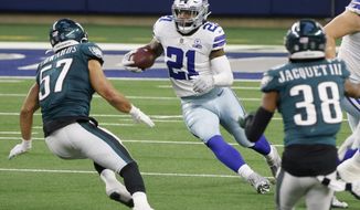 Dallas Cowboys running back Ezekiel Elliott (21) runs the ball as Philadelphia Eagles linebacker T.J. Edwards (57) and cornerback Michael Jacquet (38) close in to make the stop in the second half of an NFL football game in Arlington, Texas, Sunday, Dec. 27. 2020. (AP Photo/Michael Ainsworth)