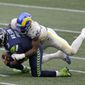 Seattle Seahawks quarterback Russell Wilson (3) is sacked by Los Angeles Rams outside linebacker Leonard Floyd (54) during the first half of an NFL football game, Sunday, Dec. 27, 2020, in Seattle. (AP Photo/Scott Eklund)