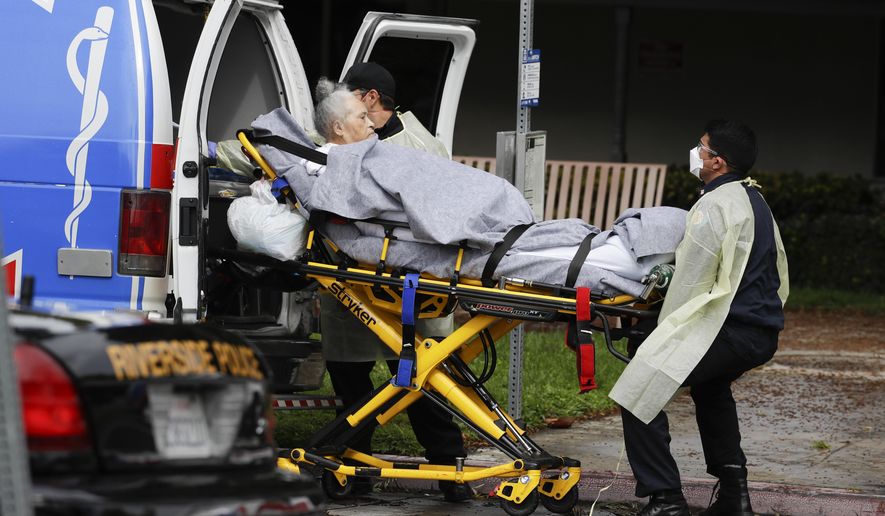 FILE - This April 8, 2020, file photo shows a patient being evacuated from the Magnolia Rehabilitation and Nursing Center in Riverside, Calif. After months spent tamping down surges and keeping the coronavirus at manageable levels, a variety of factors combined to bring California to a crisis point in the pandemic. (AP Photo/Chris Carlson, File)