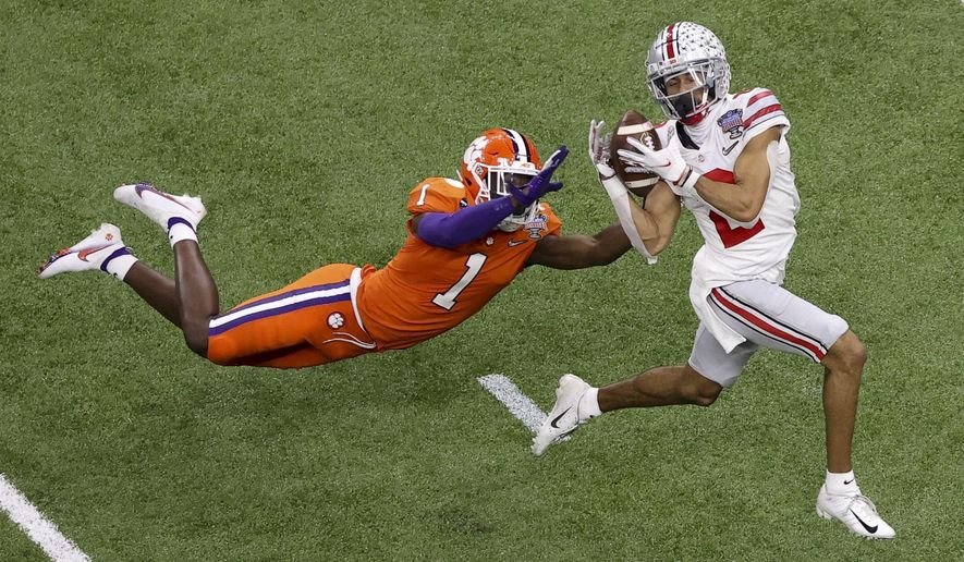 Ohio State wide receiver Chris Olave catches a touchdown pass in front of Clemson cornerback Derion Kendrick during the second half of the Sugar Bowl NCAA college football game Friday, Jan. 1, 2021, in New Orleans. (AP Photo/Butch Dill)