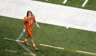 Clemson quarterback Trevor Lawrence leaves the field after their loss against Ohio State during the Sugar Bowl NCAA college football game Saturday, Jan. 2, 2021, in New Orleans. Ohio State won 49-28. (AP Photo/Butch Dill) **FILE**