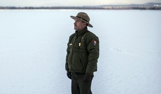 Jeremy Barnum stands for a portrait Dec. 11, 2020, on the frozen surface of Jackson Lake in Grand Teton National Park, Wyo. Barnum officially started his tenure as Grand Teton&#x27;s chief of staff in May. A native of northern Utah, his career with the U.S. Foreign Service sent him to Finland and Ecuador before landing back in Washington, D.C., where he pivoted to communications work with the National Park Service. (Ryan Dorgan/Jackson Hole News &amp;amp; Guide via AP)