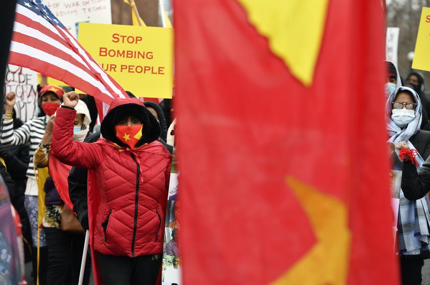 Ethiopian Negist Derso, left, raises her fist in the air as she joins others in a march in Denver on Monday, Dec. 28, 2020, to protest the ongoing war in Ethiopia. As is the case in Ethiopia, Colorado’s Ethiopian communities don’t agree about the cause of the problems in their home country, particularly over which entity is the aggressor, and they worry about their families and friends who live there. (Helen H. Richardson/The Denver Post via AP)