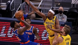 Indiana Pacers forward Myles Turner (33) attempts to block the shot of New York Knicks guard Elfrid Payton (6) during the first half of an NBA basketball game in Indianapolis, Saturday, Jan. 2, 2021. (AP Photo/Doug McSchooler)