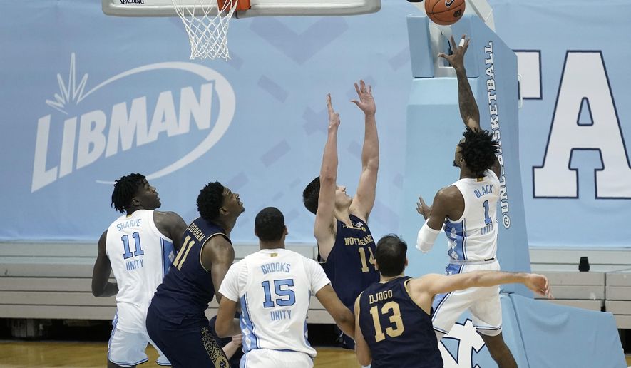 North Carolina guard Leaky Black (1) takes a shot to give his team the lead against Notre Dame late in the second half of an NCAA college basketball game in Chapel Hill, N.C., Saturday, Jan. 2, 2021. (AP Photo/Gerry Broome)