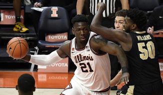 Illinois center Kofi Cockburn (21) does to the basket as he is pressured by Purdue&#39;s forward Trevion Williams (50) in the first half of an NCAA college basketball game Saturday, Jan. 2, 2021, in Champaign, Ill. (AP Photo/Holly Hart)