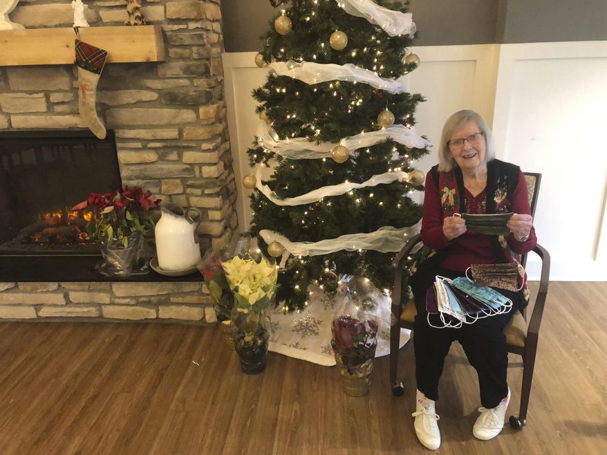 Miriam Looker, 95, displays one of the 1,700 masks she’s made since the beginning of the coronavirus epidemic using her quilting skills, on Monday, Dec. 21, 2020, in Marysville, Ohio. The only break Looker has taken from her 10-mask-a-day-routine came in November when came down with COVID-19 herself, which she said left her exhausted and needing a lot of naps. Looker is no stranger to using material to help save lives: during World War II she tested parachutes at Wright Field—now Wright Patterson Air Force Base—in Dayton. (AP Photo/Andrew Welsh-Huggins)