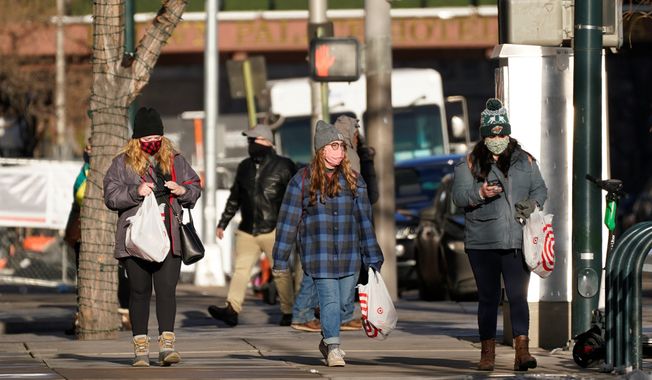 &quot;Maybe the cough is the new smoking-in-public. If you&#x27;re doing it without a face mask, you&#x27;ll be looked at awkwardly,&quot; said Dr. Panagis Galiatsatos, an assistant professor at Johns Hopkins School of Medicine.
FILE - In this Tuesday, Dec. 29, 2020, file photo, shoppers wear face masks while in search of after-Christmas bargains in shops in the Denver Pavilions in downtown Denver. U.S. health officials say the lack of reported travel history for a Colorado National Guardsman with a new variant of the coronavirus suggests it is already spreading in the U.S. Dr. Greg Armstrong of the CDC says the agency is working with a national lab to broaden the search for the variant. (AP Photo/David Zalubowski, File) (Associated Press)