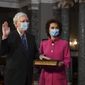 Sen. Mitch McConnell, R-Ky., participates in a mock swearing-in as his wife Transportation Secretary Elaine Chao holds a Bible, in the Old Senate Chamber at the Capitol in Washington, Sunday, Jan. 3, 2021. (Kevin Dietsch/Pool via AP)