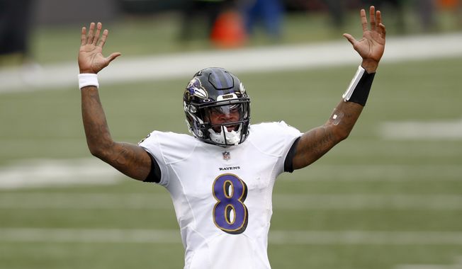 Baltimore Ravens quarterback Lamar Jackson (8) celebrates after running back J.K. Dobbins (27) ran in for a touchdown against the Cincinnati Bengals during the second half of an NFL football game, Sunday, Jan. 3, 2021, in Cincinnati. (AP Photo/Aaron Doster)