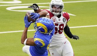 Los Angeles Rams wide receiver Robert Woods, left, catches a pass against Arizona Cardinals middle linebacker Jordan Hicks (58) during the first half of an NFL football game in Inglewood, Calif., Sunday, Jan. 3, 2021. (AP Photo/Jae C. Hong)