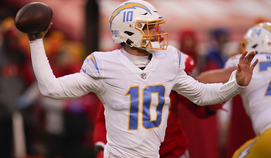 Los Angeles Chargers quarterback Justin Herbert throws a pass during the first half of an NFL football game against the Kansas City Chiefs, Sunday, Jan. 3, 2021, in Kansas City. (AP Photo/Jeff Roberson)
