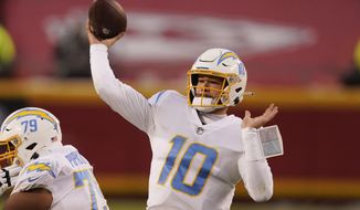 Los Angeles Chargers quarterback Justin Herbert throws a pass during the first half of an NFL football game against the Kansas City Chiefs, Sunday, Jan. 3, 2021, in Kansas City. (AP Photo/Charlie Riedel)